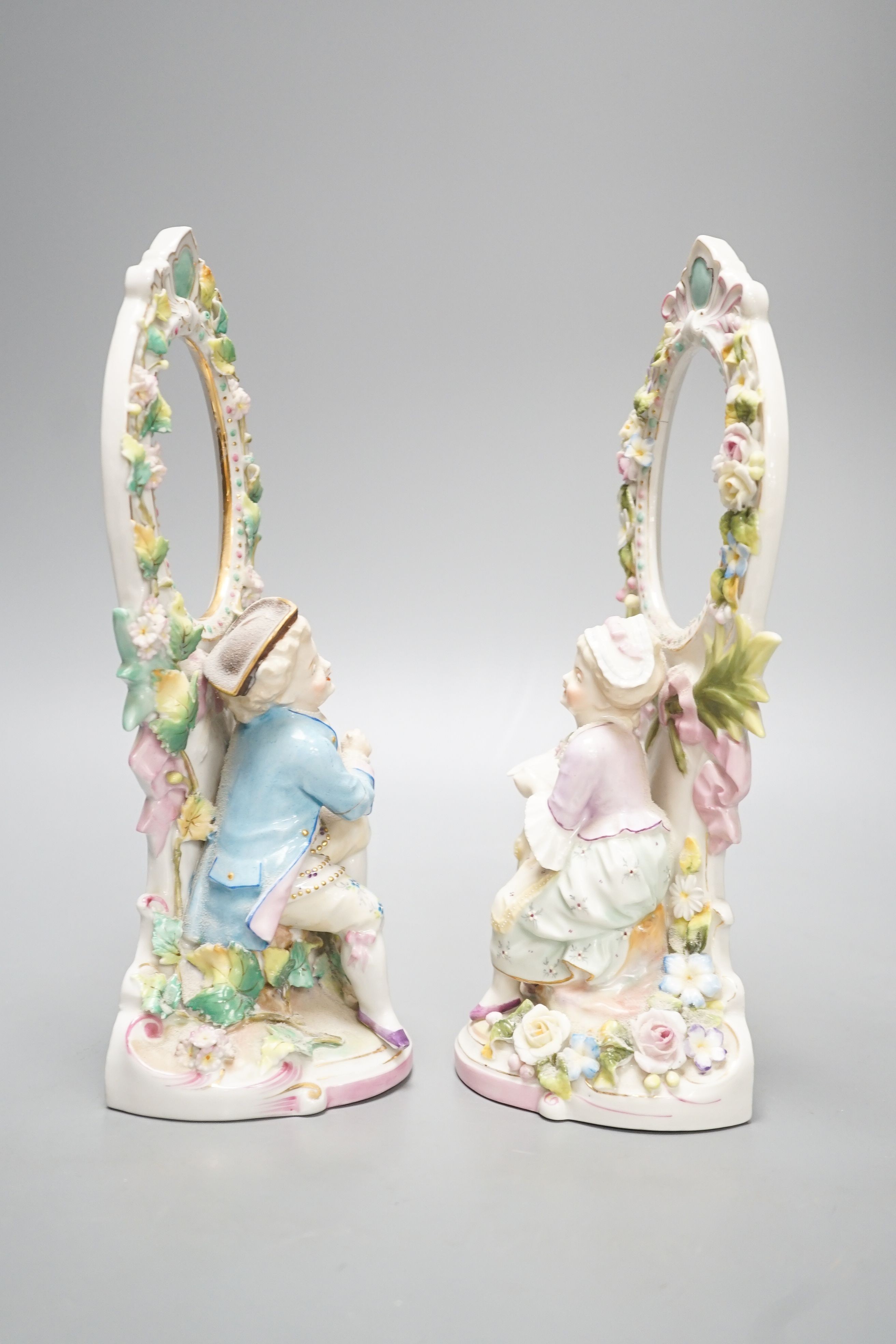 A pair of French porcelain figural photo frames, late 19th century, 24cm